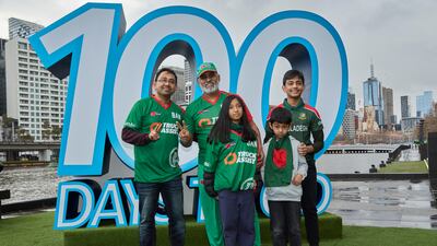 Cricket fans pose in front of the 100 days to go sign. Getty Images