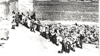 Workers carry a palm trunk into the rest house during building work in September 1932.
