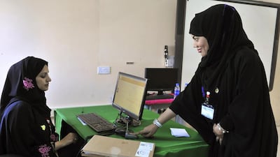 A woman has her fingerprint scanned before voting at a polling station in Muscat during Oman’s last shura council election on October 15, 2011. Said Al Bahri / Reuters
