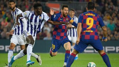 Barcelona's Argentine forward Lionel Messi vies with Valladolid's Ghanaian defender Mohammed Salisu (second left) during a league match between Barcelona and Real Valladolid at the Camp Nou / AFP / LLUIS GENE