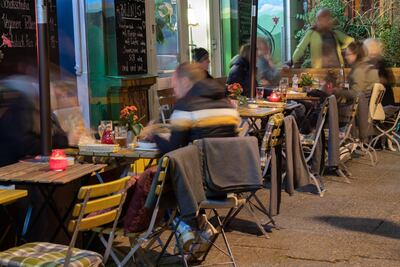 Guests sit in front of a restaurant in Berlin. EPA