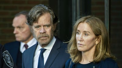 Actress Felicity Huffman, escorted by her husband William H. Macy, exits the John Joseph Moakley United States Courthouse in Boston, where she was sentenced for her role in the College Admissions scandal. AFP
