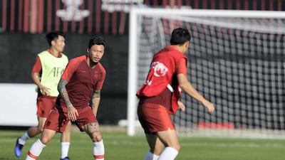 Zhang Lin Peng, centre, of China trains with his teammates at Al Wahda Academy in Abu Dhabi.