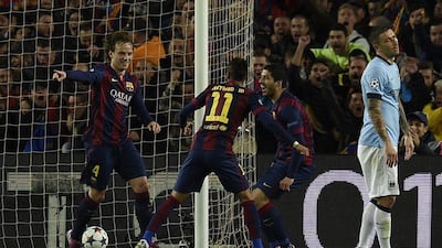 Barcelona's Ivan Rakitic, left, celebrates his goal on Wednesday night against Manchester City with teammates Neymar, centre, and Luis Suarez, right. Lluis Gene / AFP