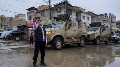 A man takes a selfie with members of the Syrian army following the withdrawal of the Kurdish-led Syrian Democratic Forces in Tabqa yesterday. Reuters