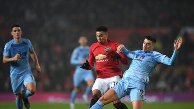 Burnley defender Matthew Lowton of Burnley tackles Jesse Lingard. Getty Images