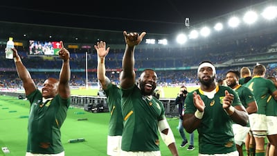 Mbongeni Mbonambi of South Africa (L) celebrates with Tendai Mtawarira (C) and captain Siya Kolisi after the World Cup semi-final victory over Wales. Getty