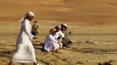Falconers participate in the Fazza Championship for Falconry during the Liwa International Festival near the Tel Mareeb dune. Christopher Pike / The National