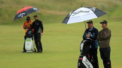 Adam Scott of Australia is sheltered from rain by his caddie Steve Williams on the 6th during the second round on day two of the 145th Open Championship at Royal Troon on July 15, 2016 in Troon, Scotland. (Photo by Mike Ehrmann/Getty Images)