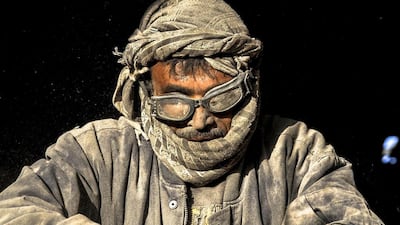 An Afghan labourer works at a plastic recycle factory in Herat, Afghanistan. Afghanistan's economy has improved, with the help of international aid, after suffering decades of fighting. JALIL REZAYEE / EPA