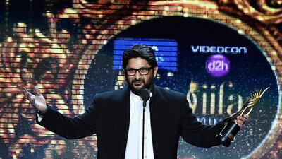 Bollywood actor Arshad Warsi receives the award for Best Performance in a Comic Role. Jewel Samad / AFP