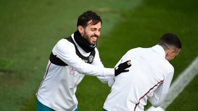 Manchester City's Bernardo Silva jokes with teammate Phil Foden. AFP