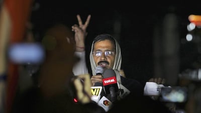 A supporter flashes a victory sign as the Delhi chief minister, Arvind Kejriwal, calls off a demonstration against the police in New Delhi. Tsering Topgyal / AP Photo