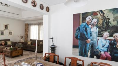 The dining area is decorated with artwork and vintage tea sets