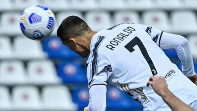 Cristiano Ronaldo heads the ball to open the scoring for Juventus during the Serie A match at Cagliari on a record-breaking night. AFP