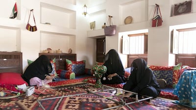From left to right, Umm Mohammed Al Mazroui, Umm Rashed, and Umm Mohammed Al Kaabi teach several traditional handicraft techniques including telli embrodery, khoos palm frond weaving and sadu cloth weaving. Reem Mohammed / The National