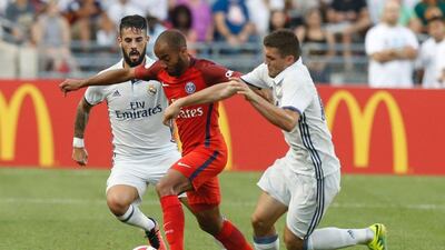 Paris Saint-Germain midfielder Lucas, centre, carries the ball between Real Madrid forward Jese Rodriguez Ruiz, left, and midfielder midfielder Mateo Kovacic during an International Champions Cup soccer match in Columbus, Ohio on July 27, 2016. AFP / Jay LaPrete