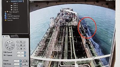 CCTV footage of the Hankuk Chemi, a South Korean-flagged oil tanker, is displayed on a screen as a boat of Iran's Revolutionary Guards is seen in red circle on the screen. AFP