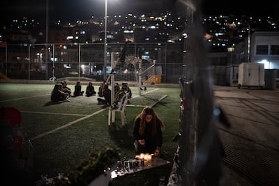 A woman lights a candle in memory of the 12 children and teens killed by rocket strike at a soccer field in the town of Majdal Shams, in the Israeli-annexed Golan Heights, on August 1. AP