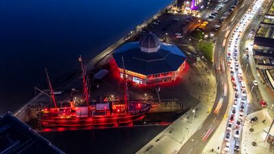 The RRS Discovery and Discovery Point in Dundee are illuminated in red light for the Light Up Red campaign. PA