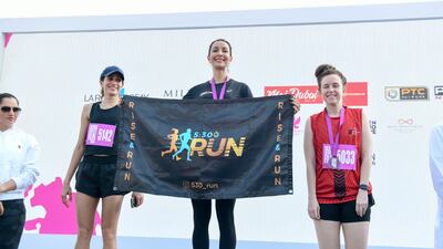 Sanaa Shawabkeh, centre, won the first place for 30-39 age category for 5kms.