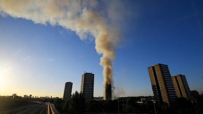 The A40 road is seen closed as flames and smoke billow as firefighters deal with the fire. Toby Melville / Reuters