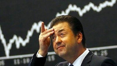 A share trader reacts as he watches the opening figures of the New York Stock Exchange yesterday.