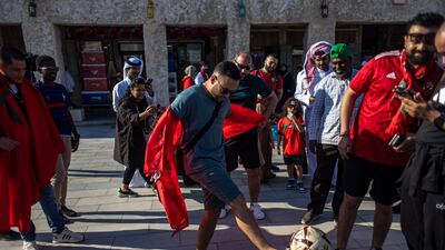 A fan of Morocco kicks a ball at the Souq Waqif market. EPA