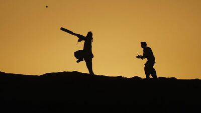 Boys are silhouetted against the setting sun while playing cricket in Karachi, Pakistan, on February 15, 2014. Athar Hussain / Reuters