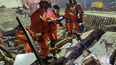 Firefighters look for residents trapped in collapsed buildings in the aftermath of a tanker truck explosion. AP