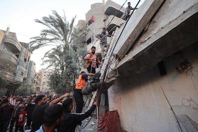 Palestinian civil defence workers extract a body from the rubble after Israeli strikes. AFP