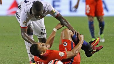 Alexis Sanchez #7 of Chile grabs his leg after being taken down by Marlos Moreno #21 of Colombia during a semi-final match in the 2016 Copa America Centernario at Soldier Field on June 22, 2016 in Chicago, Illinois. Chile defeated Colombia 2-0. Jonathan Daniel/Getty Images/AFP