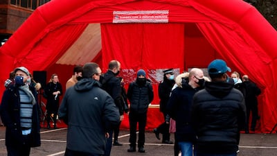 Volunteers are briefed at Woking fire station, south-west of London, as the council prepares to distribute test kits to residents to test for the South African variant of Covid-19. AFP