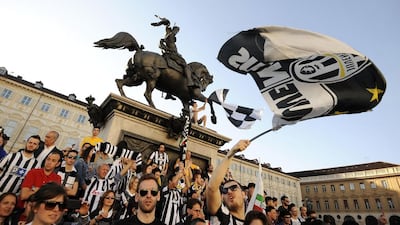 Juventus supporters gather and wave flags in central Piazza San Carlo square to celebrate their victory of the Serie A championship. Giorgio Perottino / Reuters / May 4, 2014