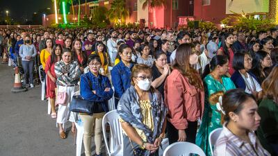 Worshippers joined together to pray and a choir dressed in red and black sang hymns during the outdoor ceremony.