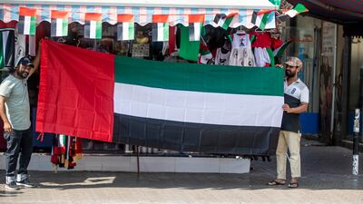 Vendors selling flags and other related items in Satwa, Dubai to celebrate flag day. Ruel Pableo / The National