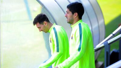 Barcelona forward pair Lionel Messi, left, and Luis Suarez, right, walk onto the training pitch. David Ramos /Getty Images