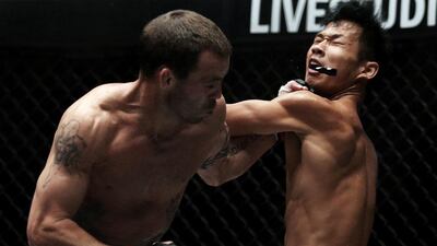 Take that: Jens Pulver, of US, connects with a booming left dislodging the mouth-guard of Zhao Ya Fei of China during the One Fighting Championship, Bantamweight Grand Prix in Singapore. Chris McGrath / Getty Images