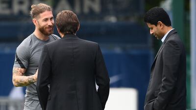 Sergio Ramos with PSG's sporting director Leonardo, centre, and president Nasser Al-Khelaifi. AFP