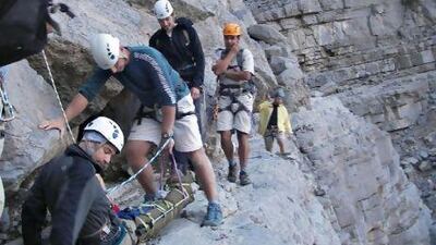 Members of the volunteer rescue team assisting Cameron Brooks, 43, after his 10-metre tumble in Wadi Ghalilah on Saturday.