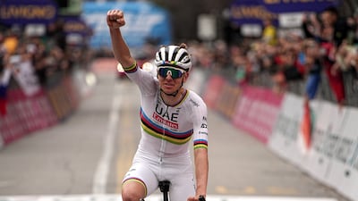 Reigning world champion Tadej Pogacar celebrates as he crosses the finish line to win the Giro di Lombardia. AP