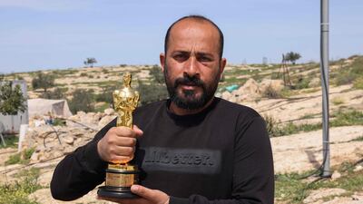 Palestinian filmmaker and Oscar winner Hamdan Ballal poses with his Oscar in his village of Susya in the occupied West Bank. AFP