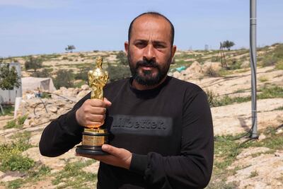 Palestinian filmmaker Hamdan Ballal, with his Oscar, which he won for the documentary No Other Land. AFP