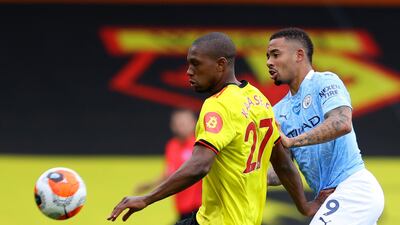 Manchester City's Gabriel Jesus, right, duels for the ball with Watford's Christian Kabasele. AP
