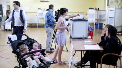 A woman votes in Dublin while her children wait in their pushchair as Ireland held a referendum on liberalising its abortion law on May 25, 2018. Max Rossi / Reuters