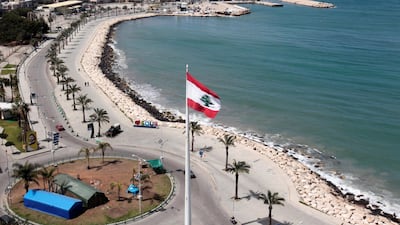 A national flag flutters at a nearly deserted corniche, during a countrywide lockdown in the southern city of Tyre, Lebanon. Reuters