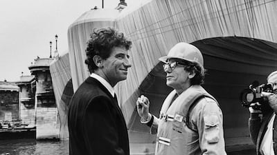 French culture Minister Jack Lang chats with Christo in Paris in 1985 during the work in progress of the Pont Neuf wrapped by the artist. AFP