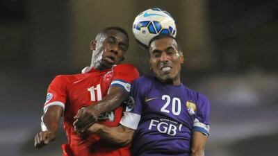 Al Ahli's forward Ahmed Khalil (L) vies for the header with Al Ain's midfielder Helal Saeed during their AFC Champions League football match at Sheik Hazza Bin Zayed stadium in Al-Ain, on May 27, 2015. AFP PHOTO