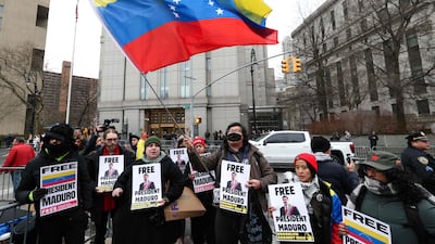 Demonstrators hold signs in support of Mr Maduro outside the Daniel Patrick Moynihan United States Courthouse in New York. AFP