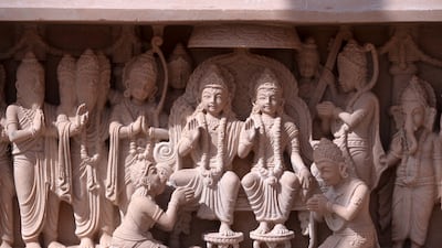 When the temple opens in February 2024, visitors will see these pink sandstone carvings that recreate stories from Hindu scriptures. Victor Besa / The National